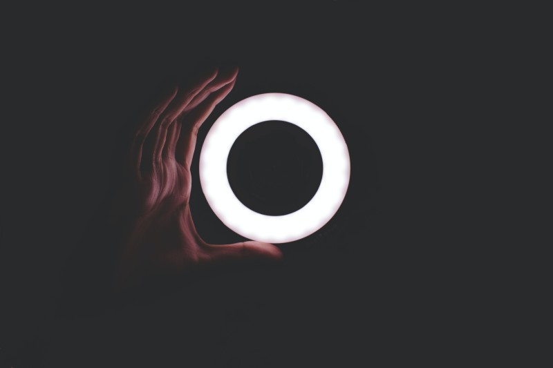 Image of a hand holding a circle of light