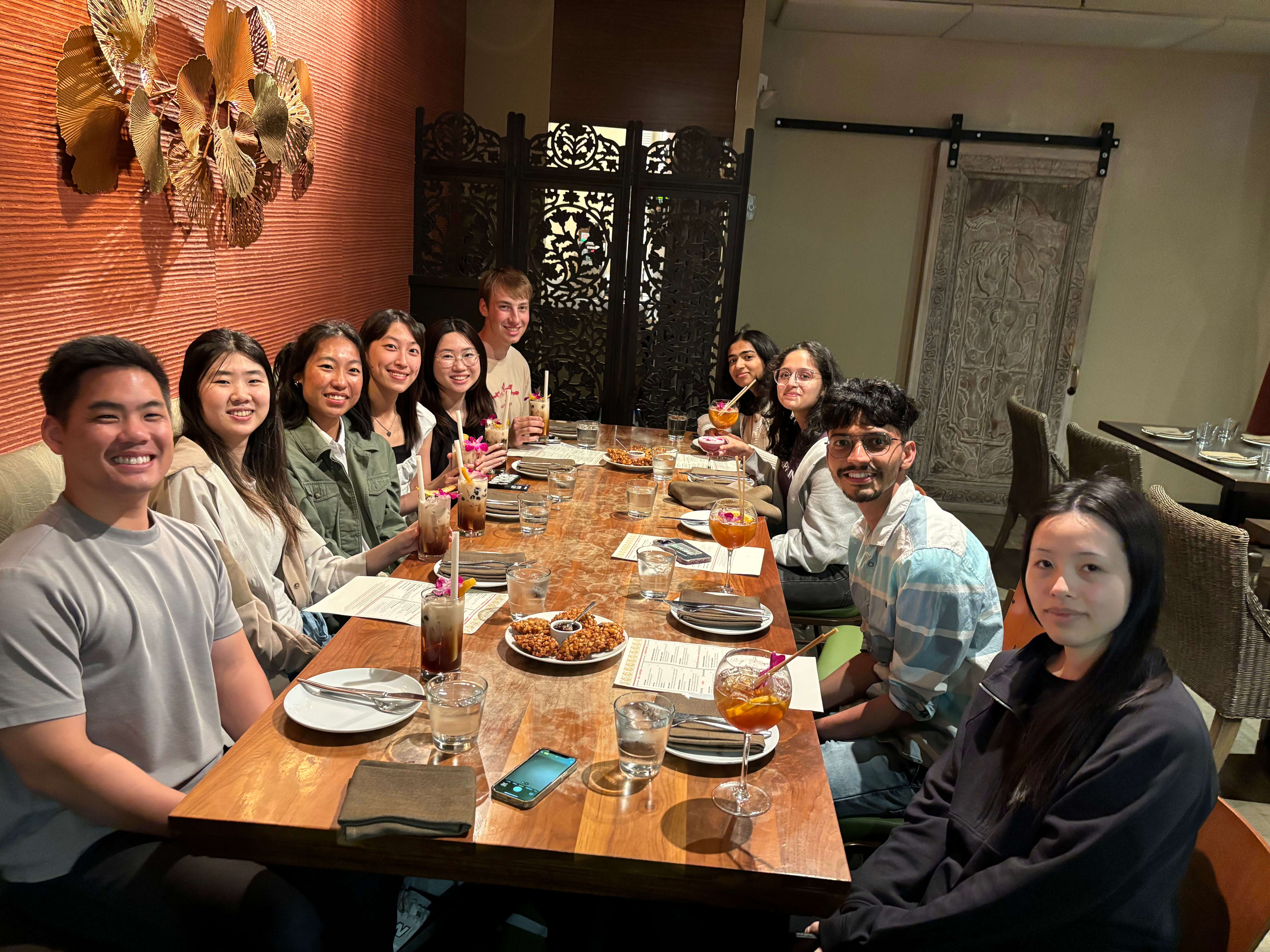 A group of Rippling interns at a dining table together.