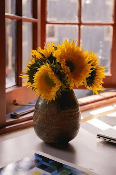Fresh sunflowers in a one of a kind vase by Peter Speliopoulos