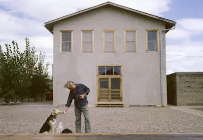 Donald Judd with family dog Rifle. Photo 1984.