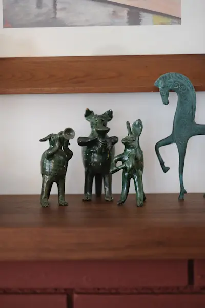 Figurines above fireplace mantle