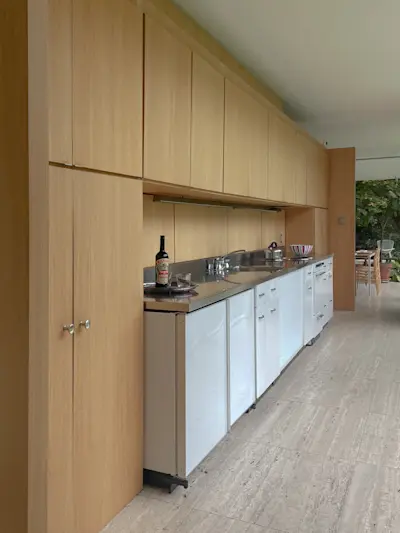 View of the kitchen. The countertop was obsessed over by Mies until the factory could produce it with integrated backsplash, sink and drying area all in a single piece of stainless steel.