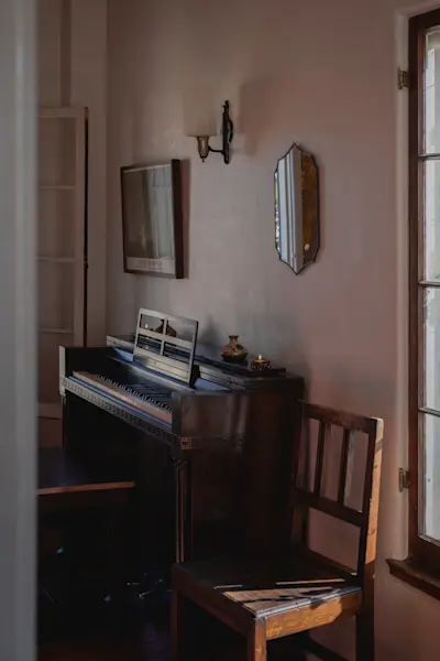 Reimi Mirror 02 hangs on the wall with Lisa Eisner Urchin Votives on the piano.