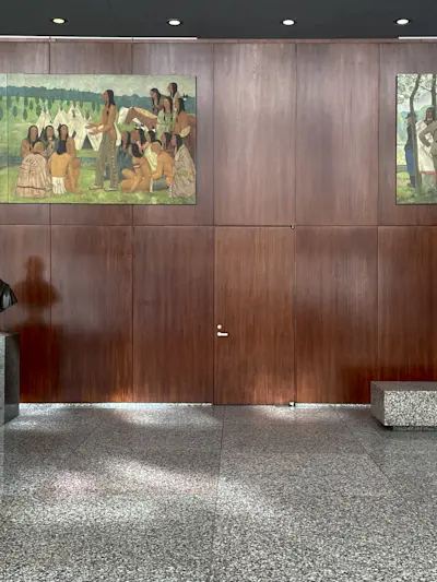 The same grid of terrazzo that lines the courtyard and composes seating and planter elements.