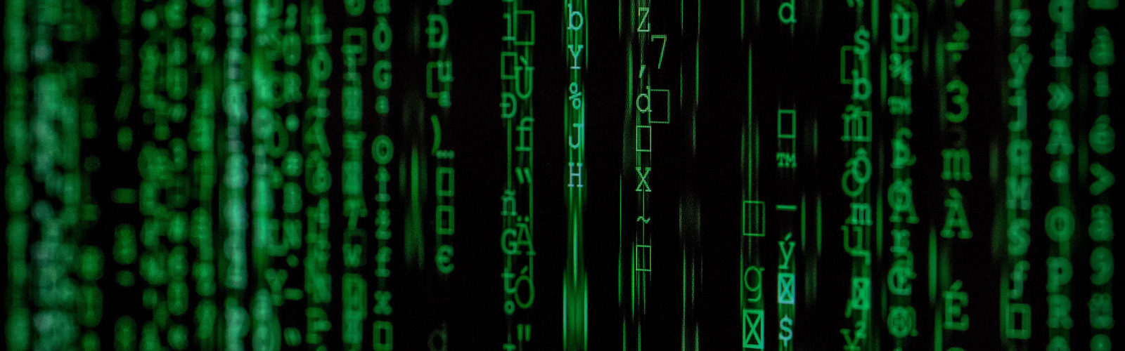 Random letters and characters in green font on a black background as a representation of Artificial Intelligence (AI)