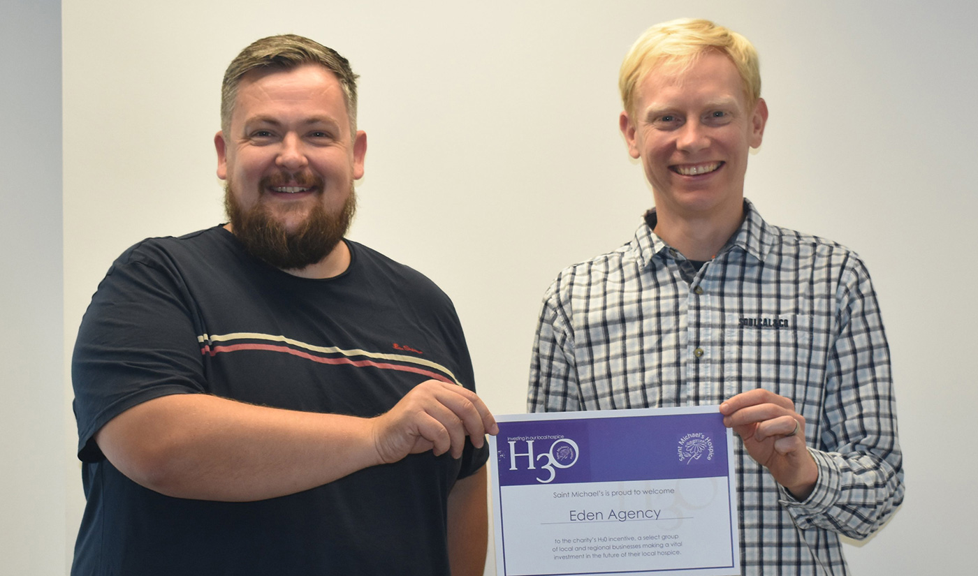Eden directors Craig and Andy stood together holding a certificate