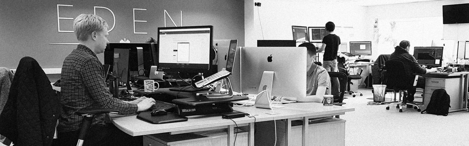 People working at their desks in the Eden Agency office