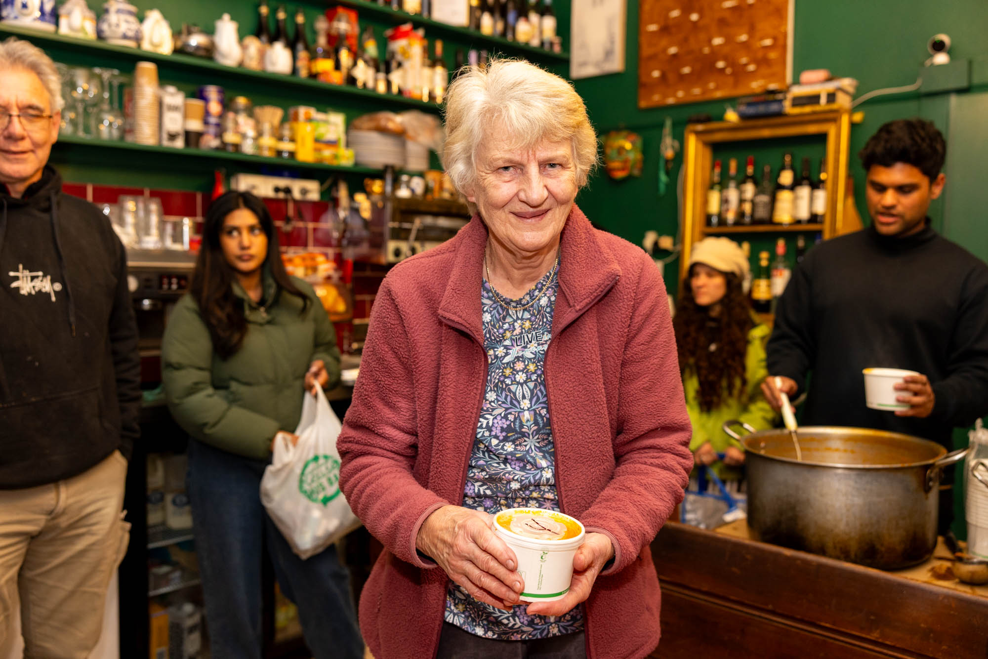 Volunteer Dianne with a container of soup to warm the body and the spirit. Image credit: Phoebe Pratt / City of Sydney