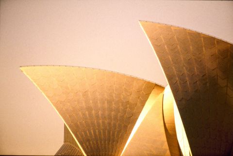 Golden late afternoon light illuminates the sails of the Opera House. Photo: City of Sydney Archives, A-00048879.