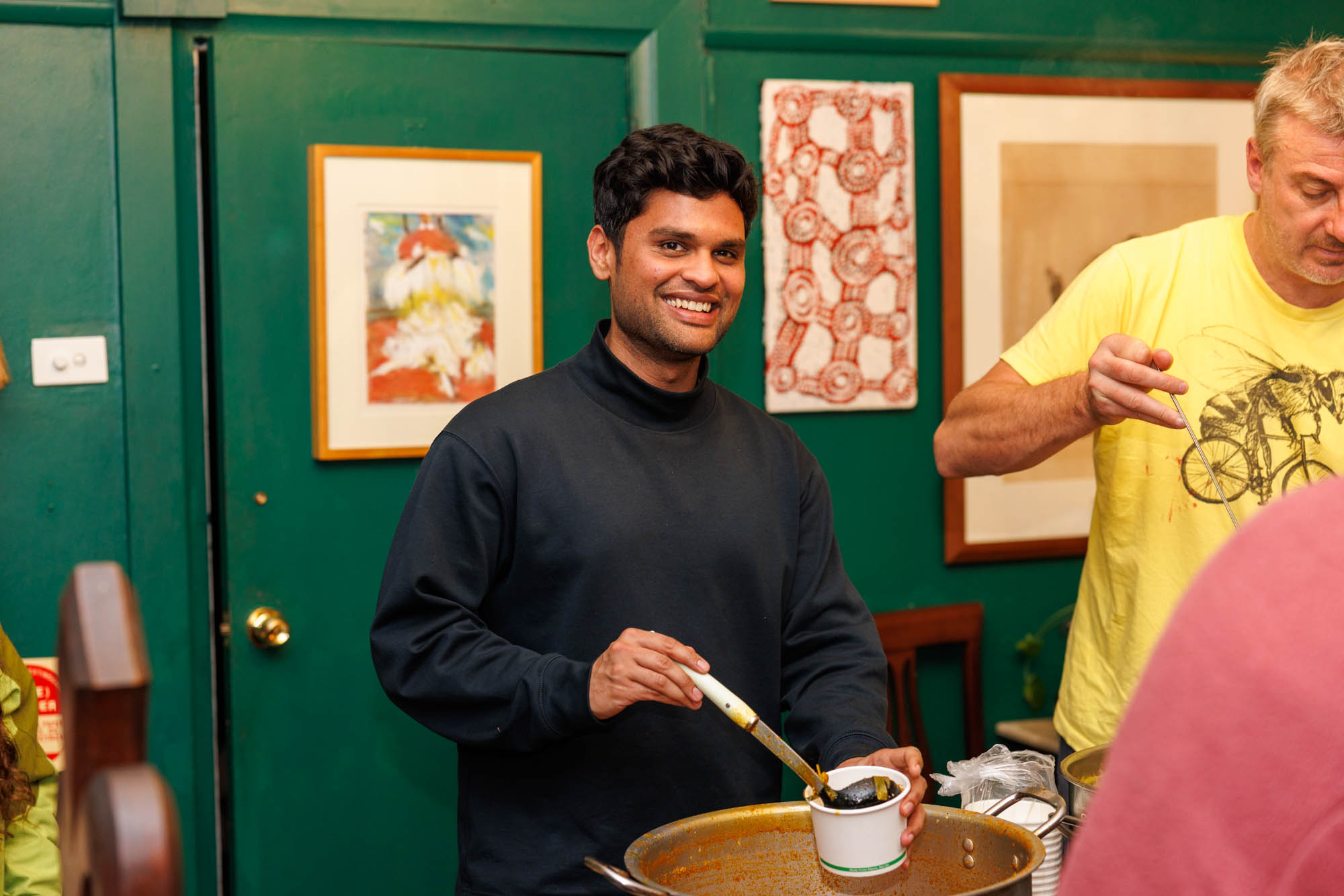 Volunteer Vinay lends a hand. You can help in the same way or donate goods or funds. Image credit: Phoebe Pratt / City of Sydney
