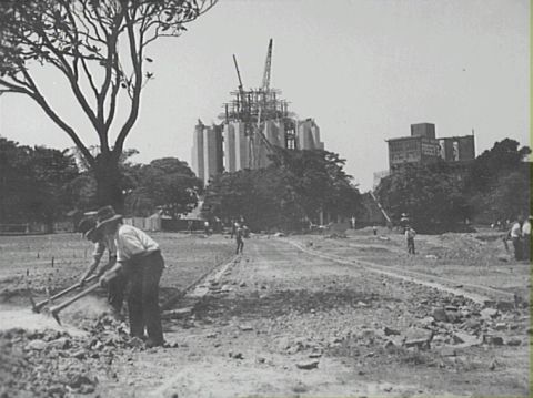 Workmen digging with pickaxes. Construction of Anzac War memorial and pool of reflection, December 1932. Credit: City of Sydney Archives.