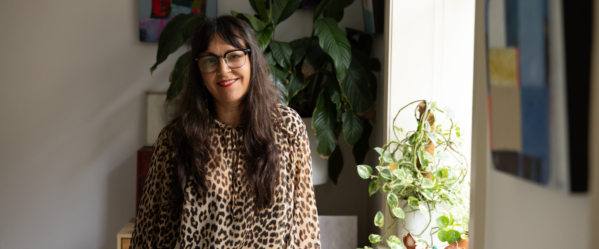 Angie Goto surrounded by art in her apartment. Image: Brendan Blacklock/City of Sydney