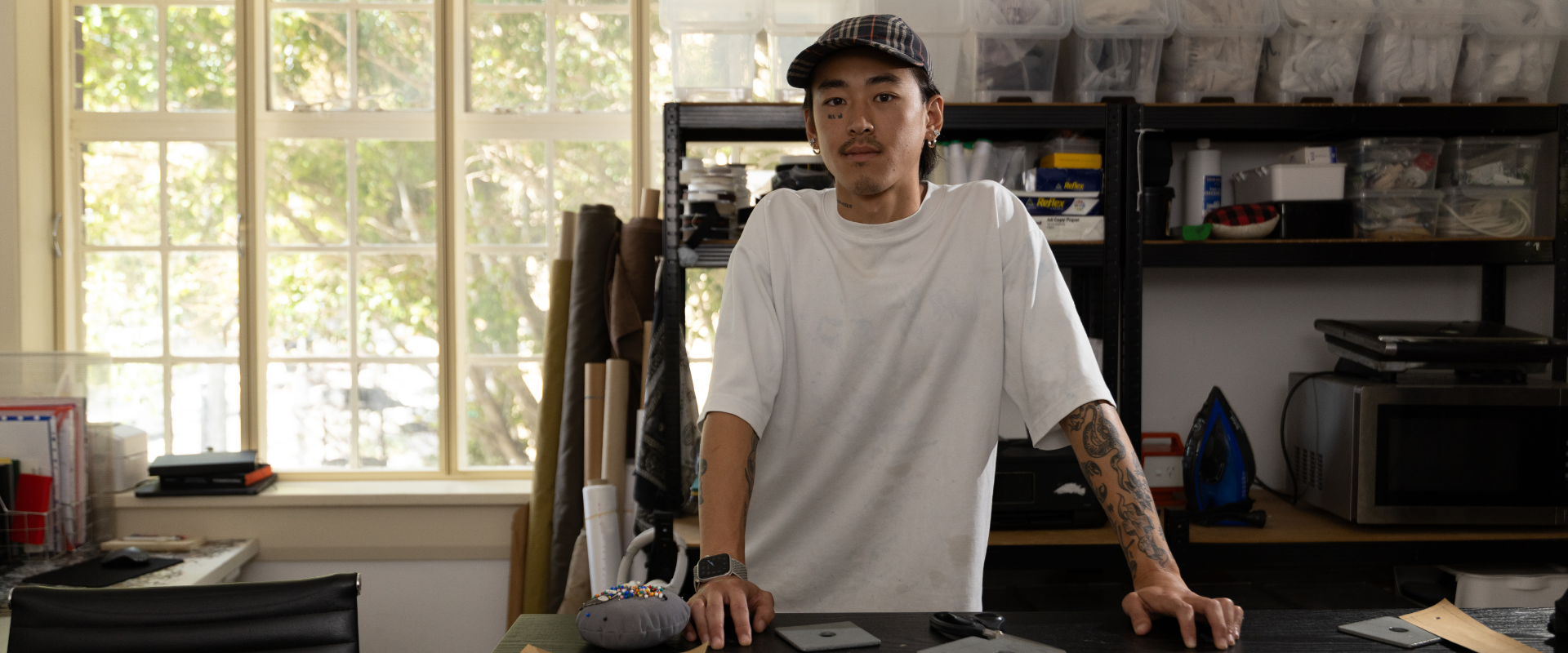 Joshua Lee marking up patterns at his cutting table. Image: Brendan Blacklock/City of Sydney