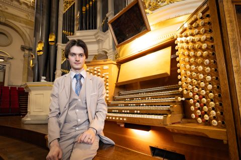 Titus sits with the Town Hall organ during a practice session. Image: Abril Felman, City of Sydney