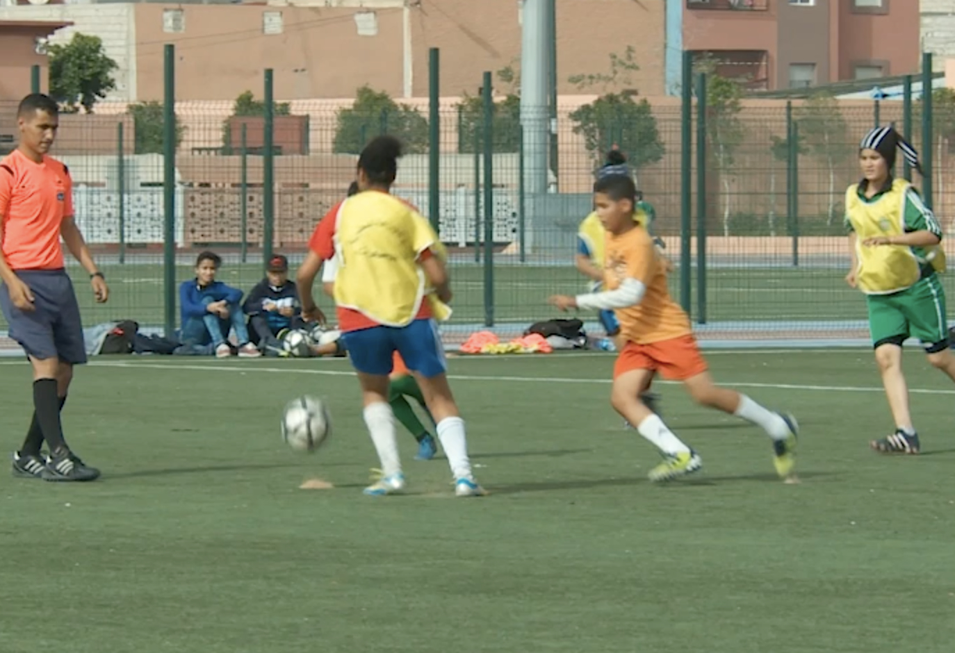 Mixed football training: junior women's team against younger boys in