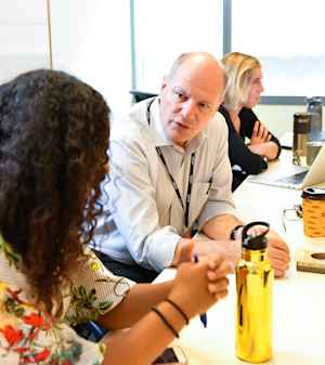 Fernando Holguin, MD, talks to a female CU student