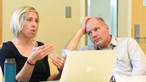 A physician listens to an environmental engineer speak during a group discussion about the study.