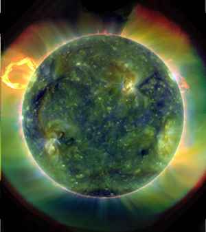 A scientific image of a solar flare showing green and yellow colors