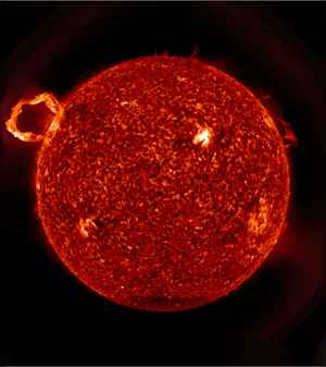 A scientific viewpoint of a solar flare showing red and orange colors.