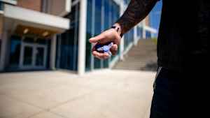 A veteran holds a fidget spinner in his right palm, which he uses when he is feeling anxious.