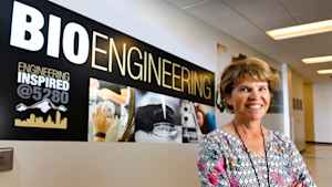A female faculty member stands in front of a