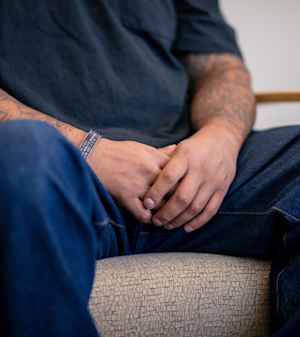 A man's hands clasp together