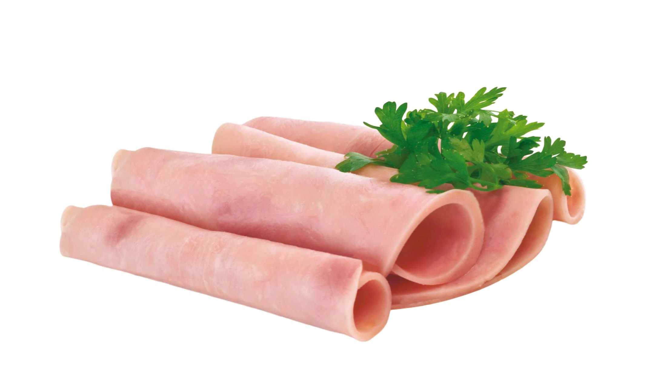 Rolled slices of vegan deli ham arranged neatly, garnished with fresh green parsley on a white background.
