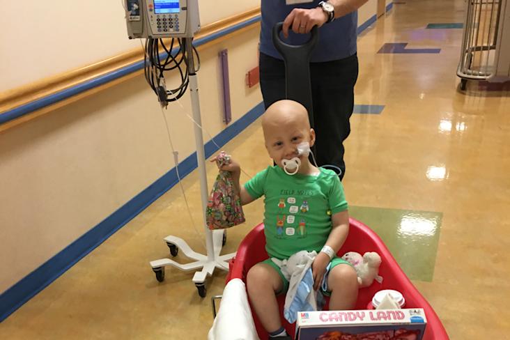 Starlight kid Luke in the hospital being pushed in a wagon
