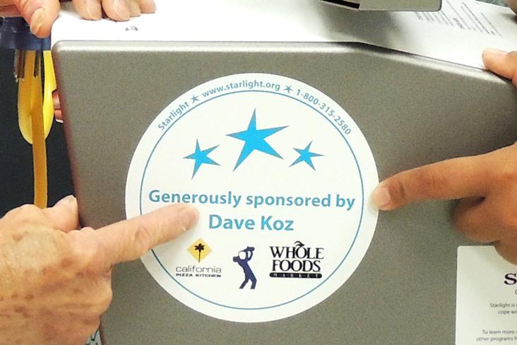 A Wii gaming station with a sticker "Generously sponsored by Dave Koz"