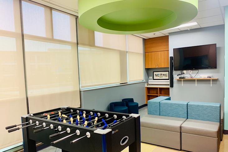 Updated Tween Room at Dell Children's Medical Center with a foosball table, computer, and tv