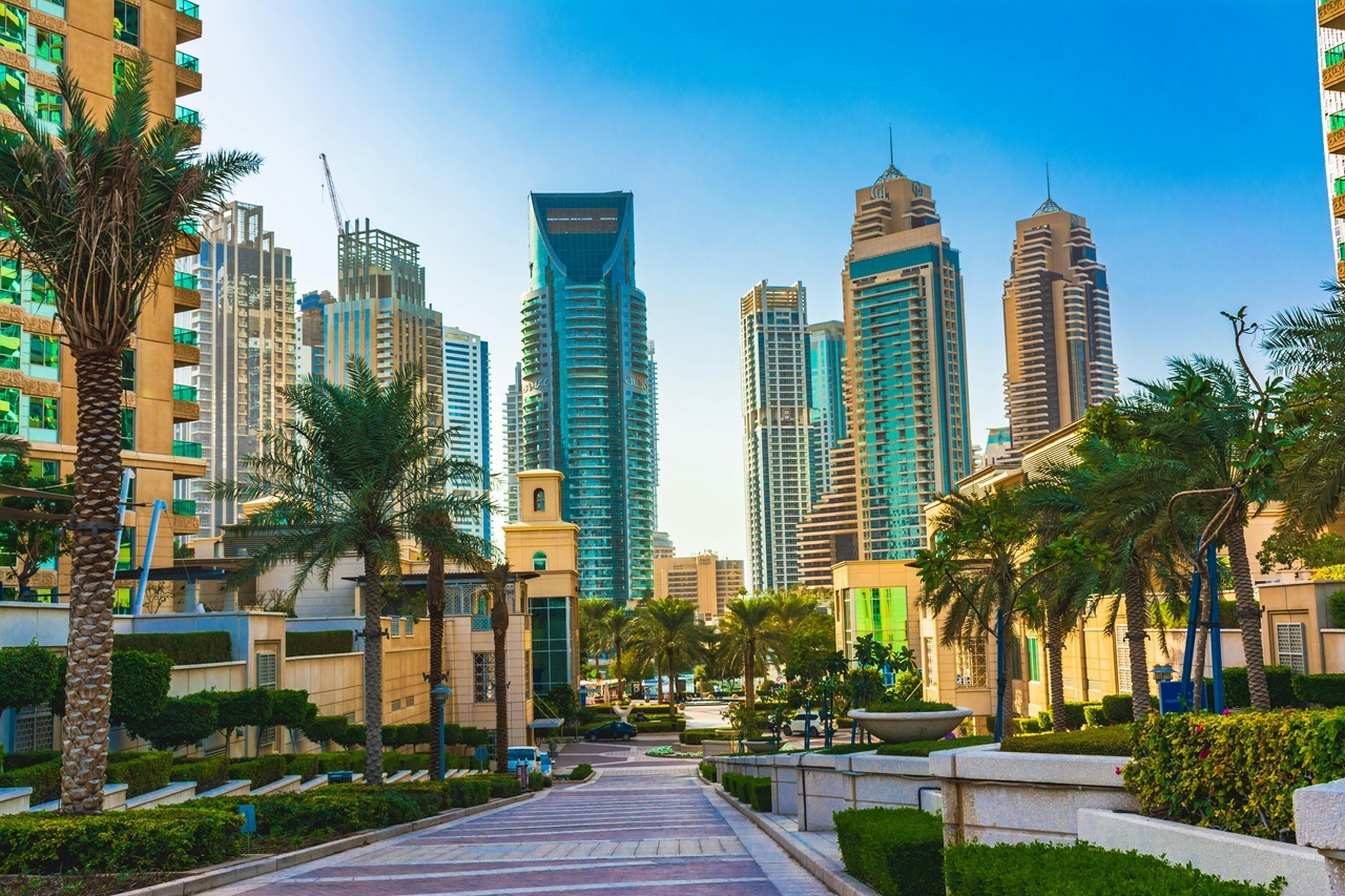 Dubai-s skyline at sunset, featuring prominent hotels and tourism landmarks