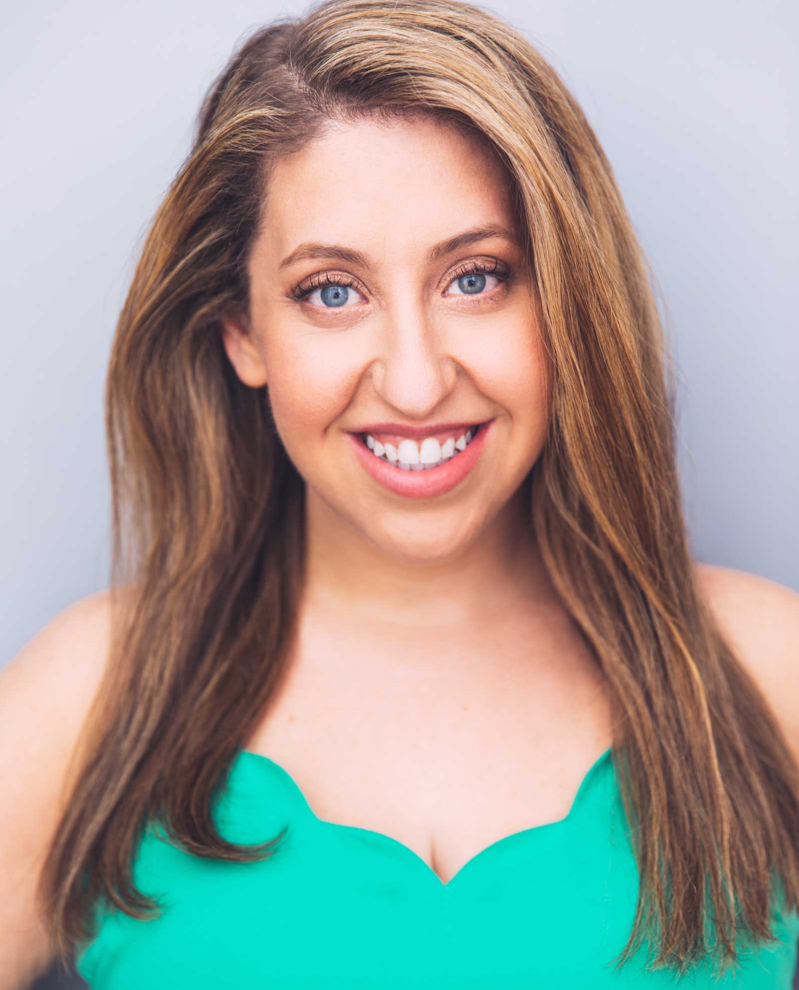 Pam Schuller headshot in bright teal top