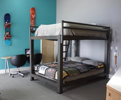 A charcoal King Over King Bunk Bed in a teenager's room.