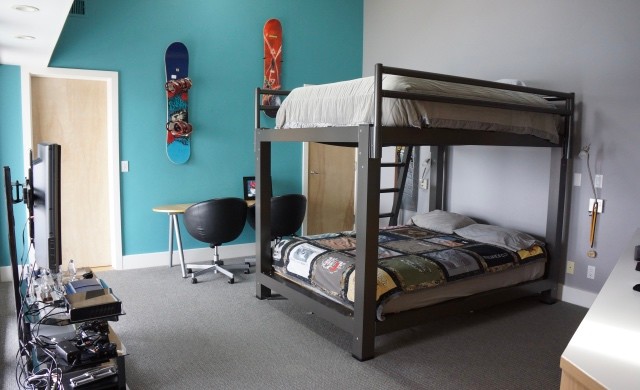 A charcoal King Over King Adult Bunk Bed in a teenager's room