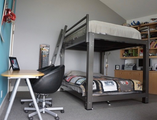 A charcoal King Over King Adult Bunk Bed in a teenager's room