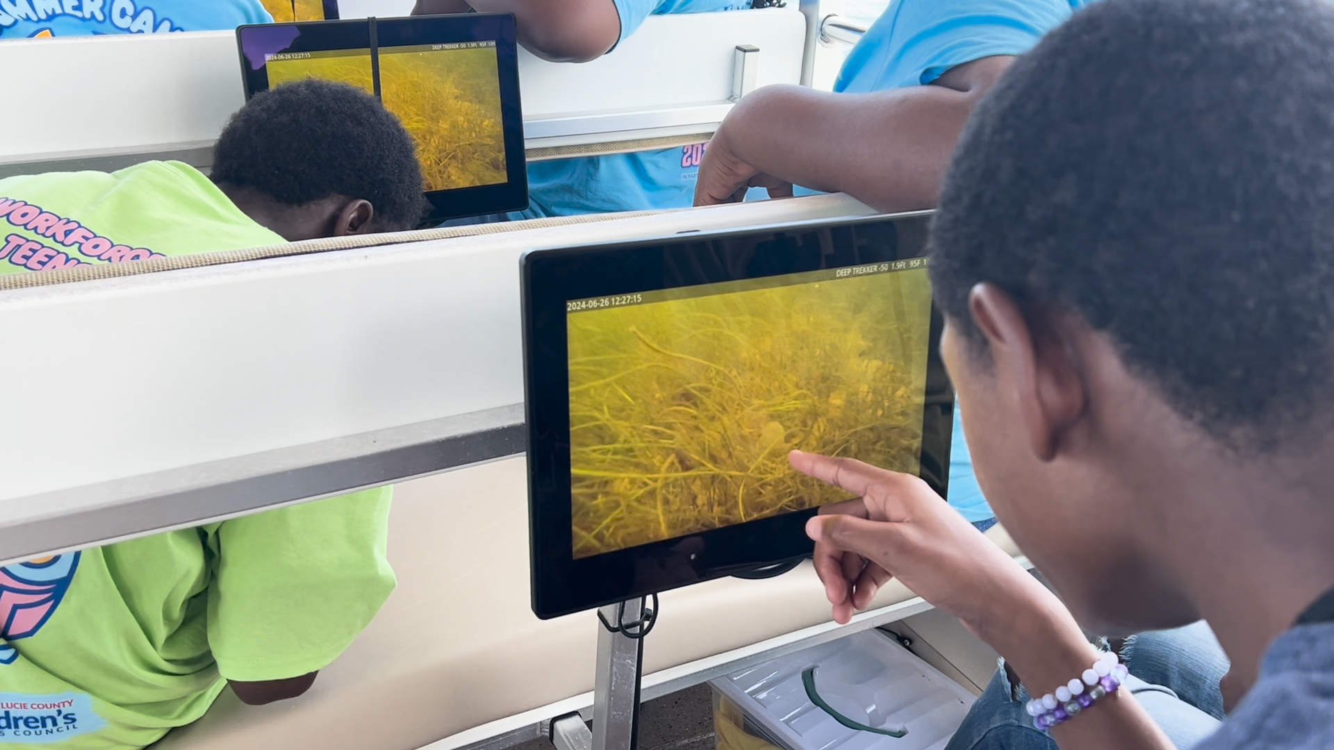 Image of child pointing to something on screen