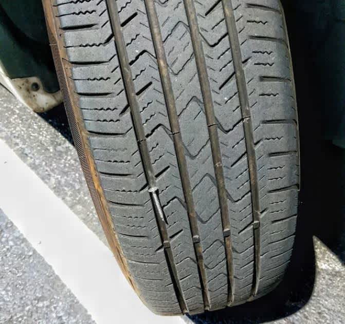 Almost Screwed nail between tire treads