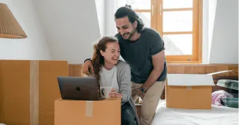 Man and woman laughing at the computer.