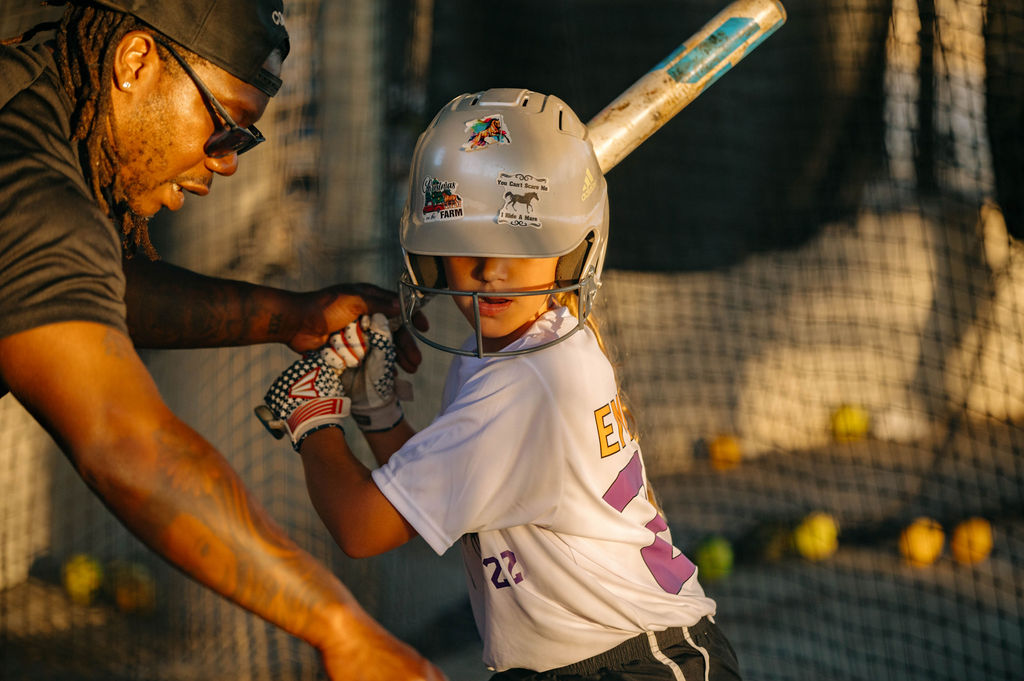 Chaos girl hitting in the cage with coach