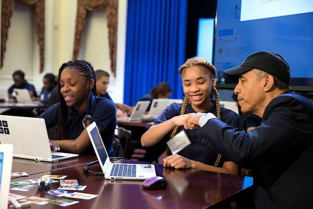 President Barack Obama fist bumps a middle-school student