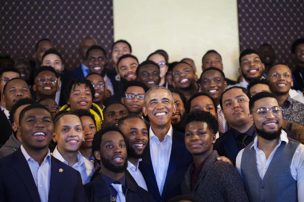 President Obama stands in the middle of young leaders at MBK Rising! All men are dressed professionally and have a range of light to deep skin tones. 