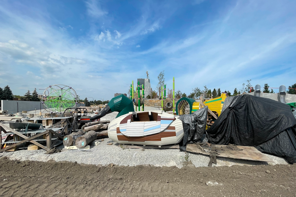 A photograph of several pieces of equipment for the Obama Presidential Center Playground. The image features a large wooden duck with a green head and a brown, light colored body with blue and dark brown stripes on it.