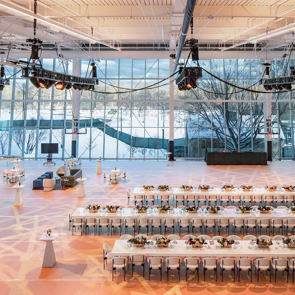 Main Court, the Obama Presidential Center’s basketball arena is set up with several long white banquet tables covered with several flower pots.