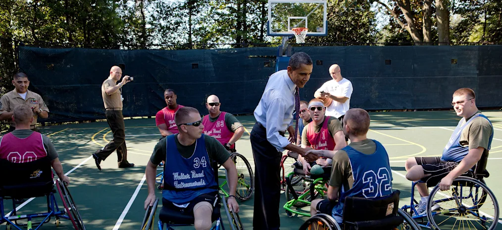 President Barack Obama greets players during a Wounded Warrior basketball game