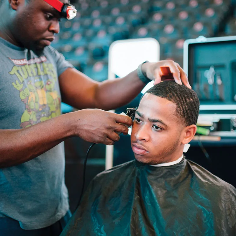 A young man gets a haircut at the My Brother's Keeper Alliance Youth Opportunity Summit in Newark, New Jersey.