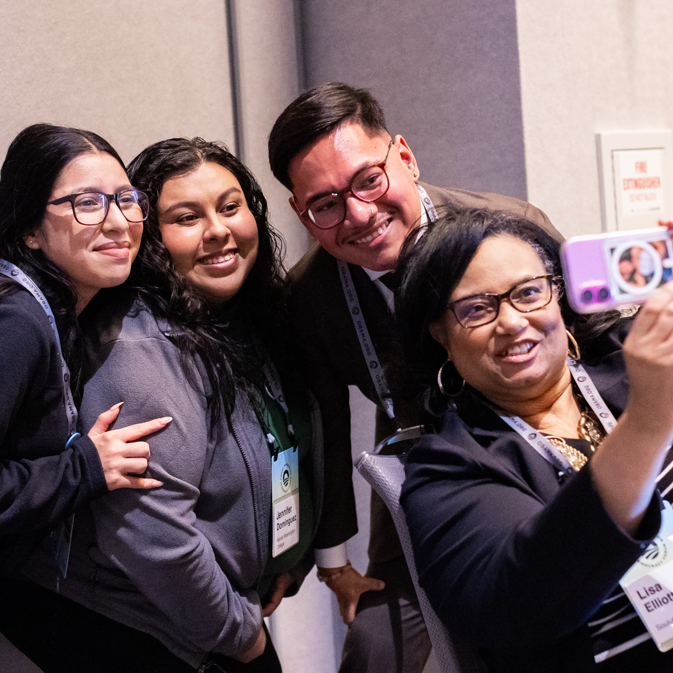 Program participants pose for a selfie at the 2024 Democracy Forum. All are a range of light and medium skin tones.