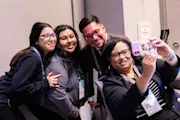 Program participants pose for a selfie at the 2024 Democracy Forum. All are a range of light and medium skin tones.
