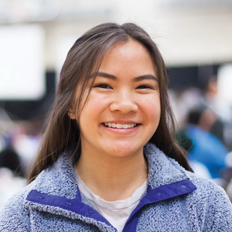 A young woman smiles to camera at the Obama Foundation Training Day in Boston in 2017.