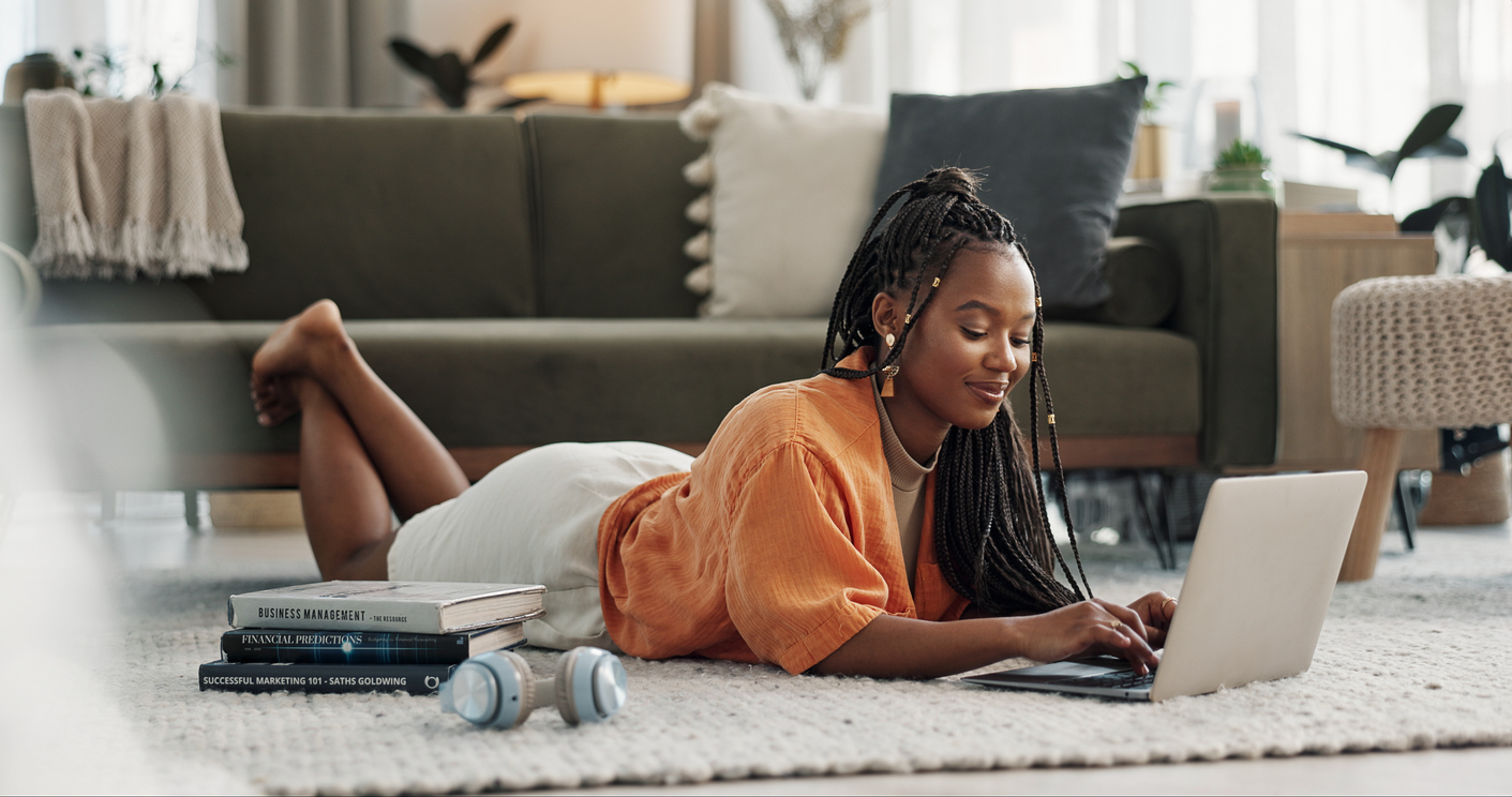 Woman lays on floor with computer