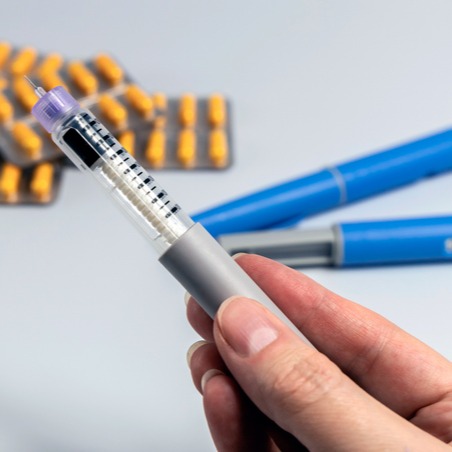 Hand Holding Ozempic Injection Pen